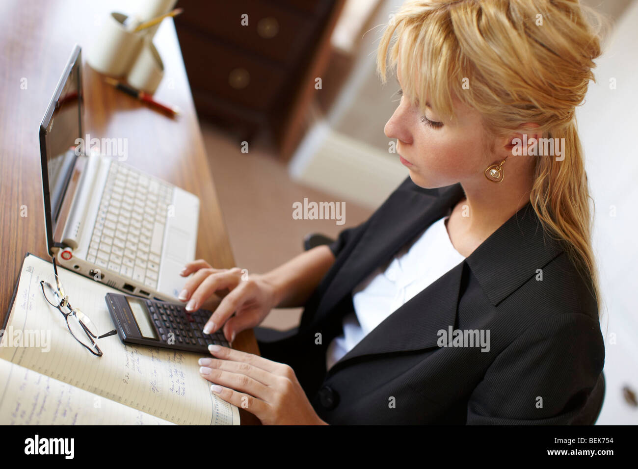 Woman working out finances Stock Photo