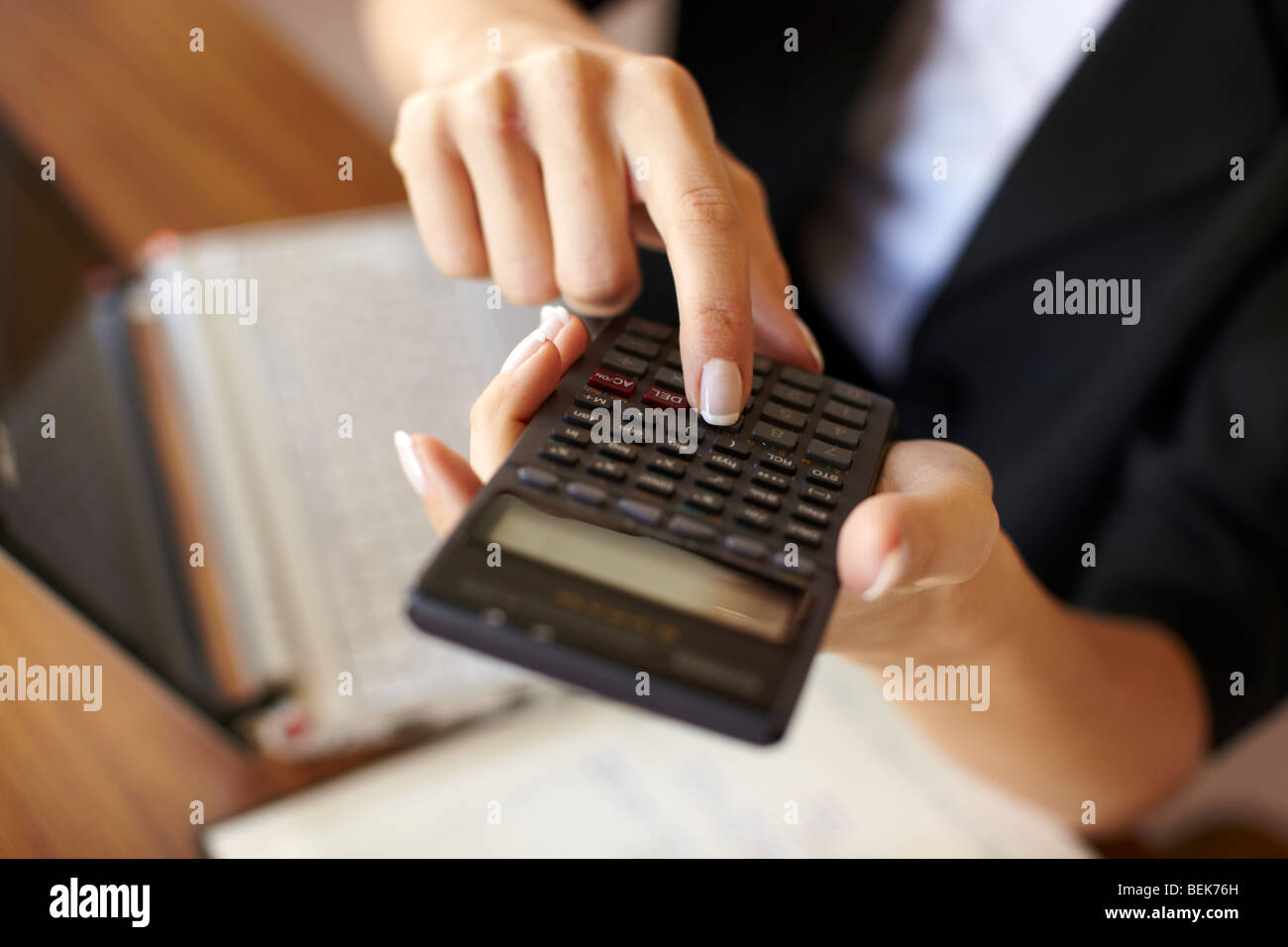 Woman working out finances Stock Photo