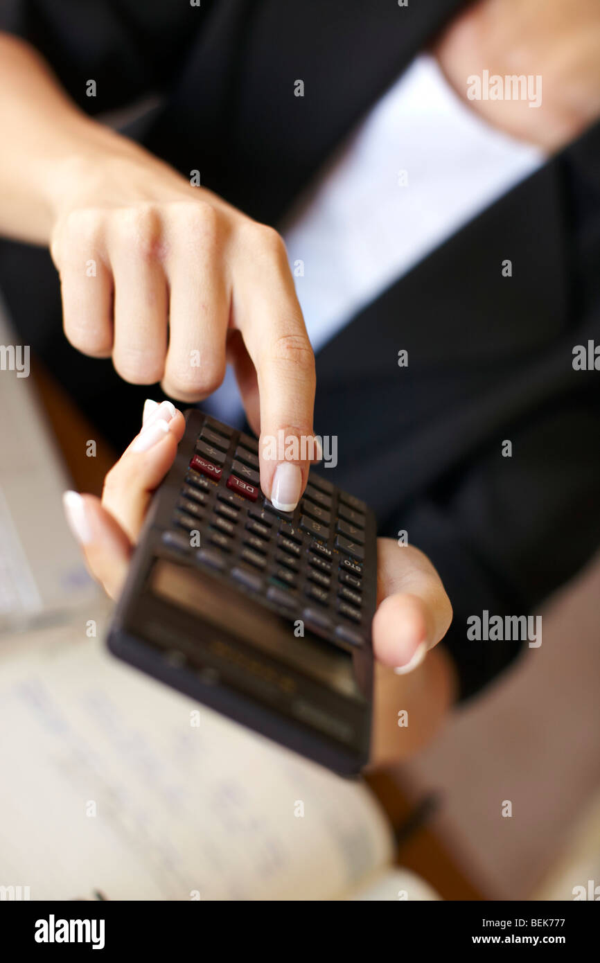Woman working out finances Stock Photo