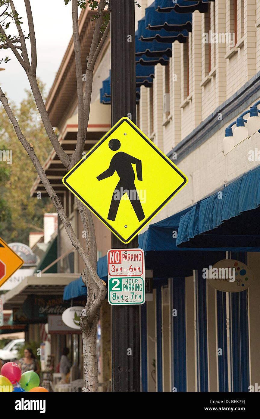 Bright yellow pedestrian crossing sign in Orange, CA. Stock Photo