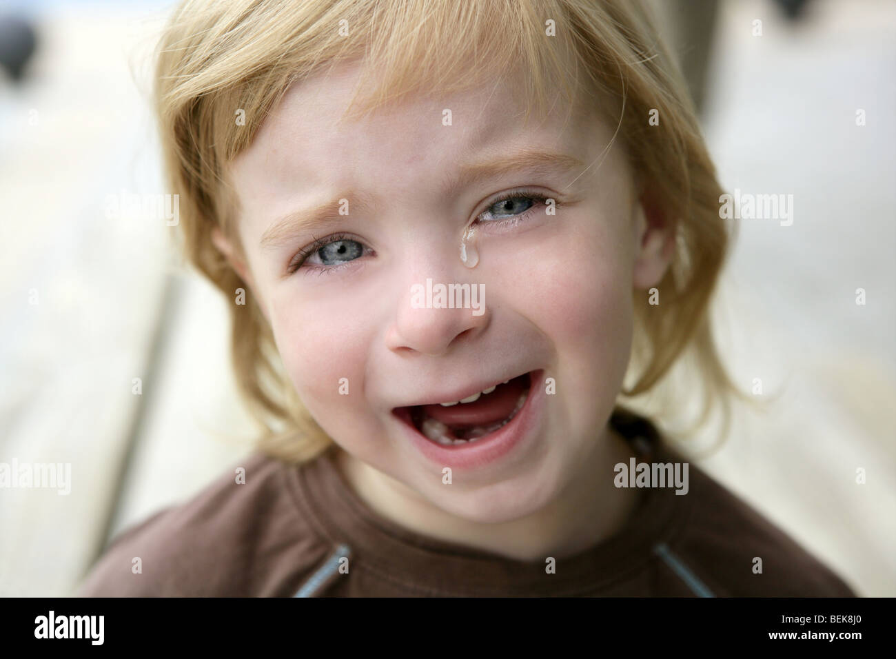 Adorable blond little girl crying closeup portrait Stock Photo