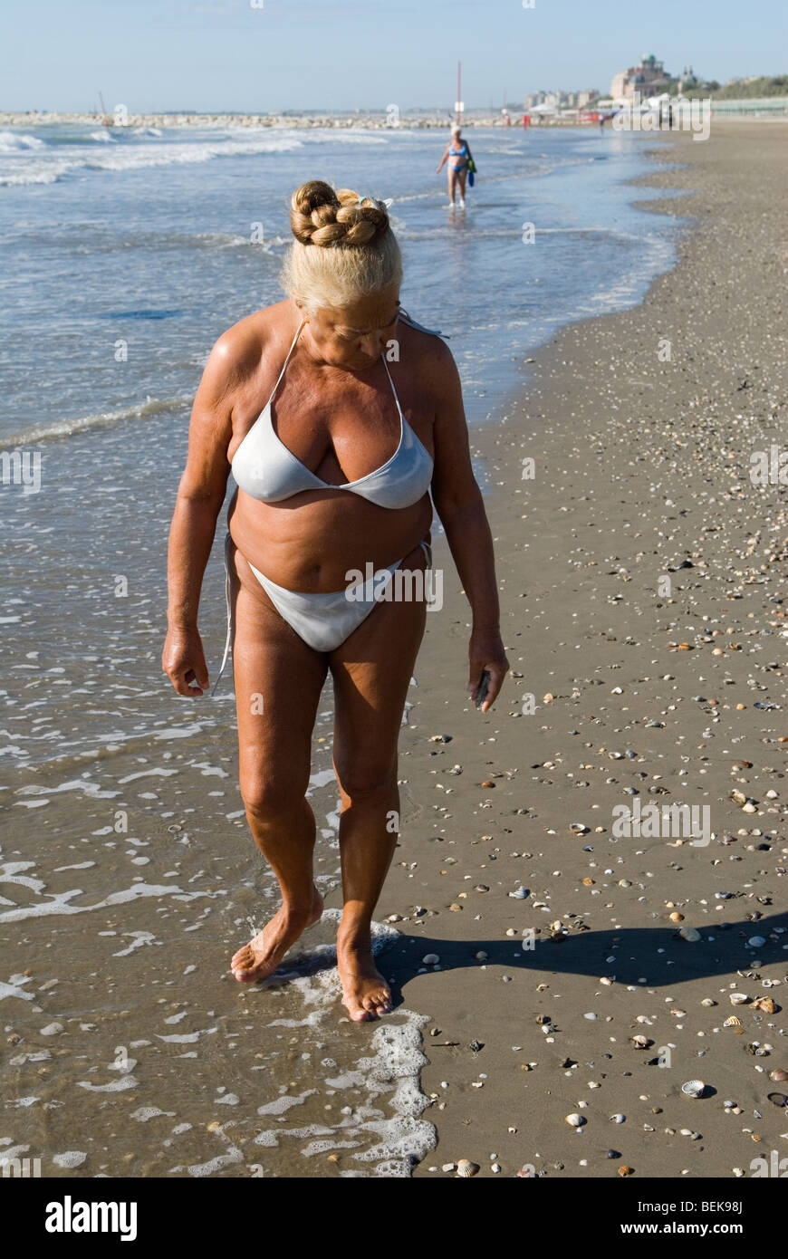 Gender fluid person mature senior androgynous woman man healthy fit body wearing white bikini Venice Lido beach Italy 2000s. 2009 HOMER SYKES Stock Photo