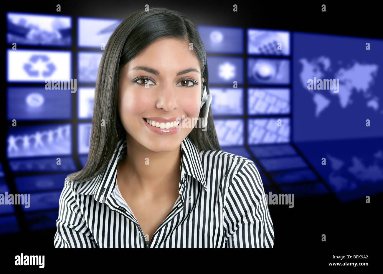 Beautiful indian woman television news presenter with multiple screen background Stock Photo