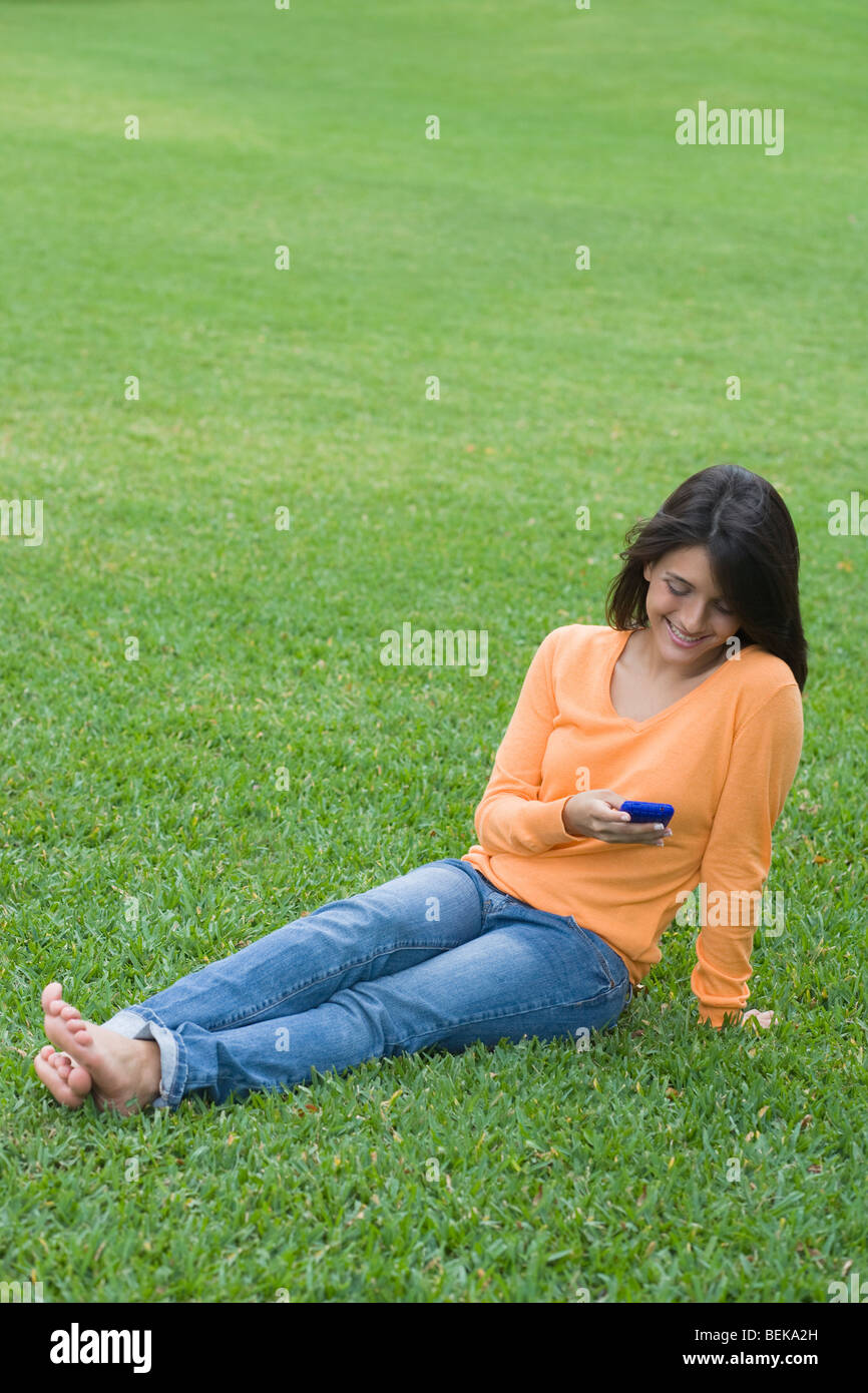 Teenage girl reading a text message on a mobile phone Stock Photo