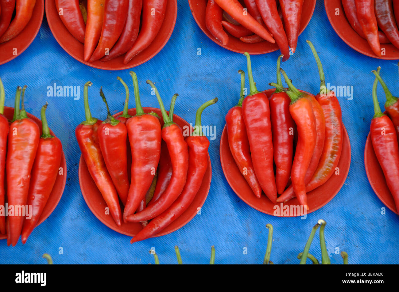 Red Hot Chili Peppers, Cayenne Peppers or Chilli Peppers in Red Bowls on Display in a Kuching Street Market Sarawak Malaysia Borneo Stock Photo