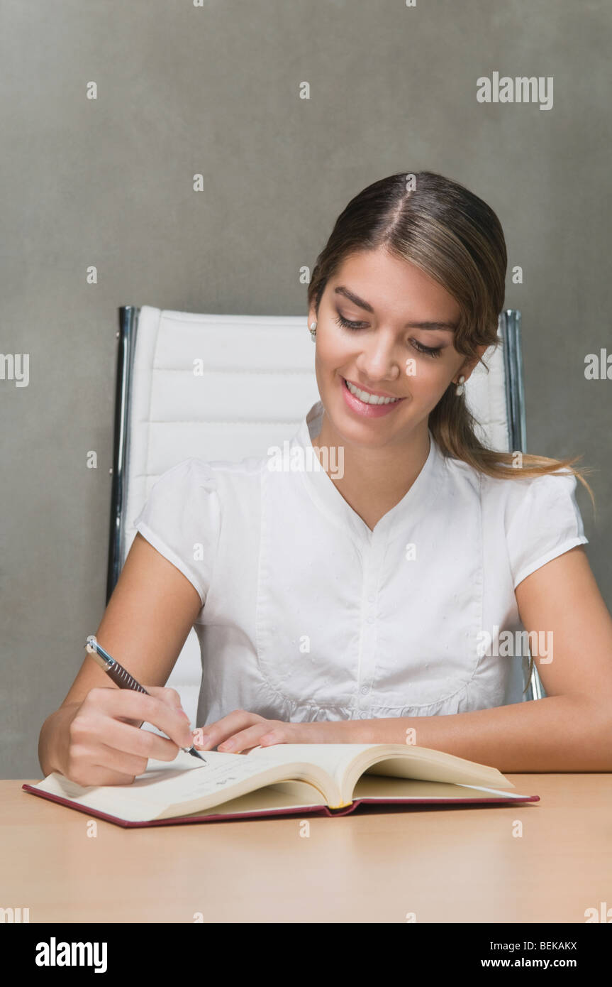 Businesswoman working in an office Stock Photo - Alamy