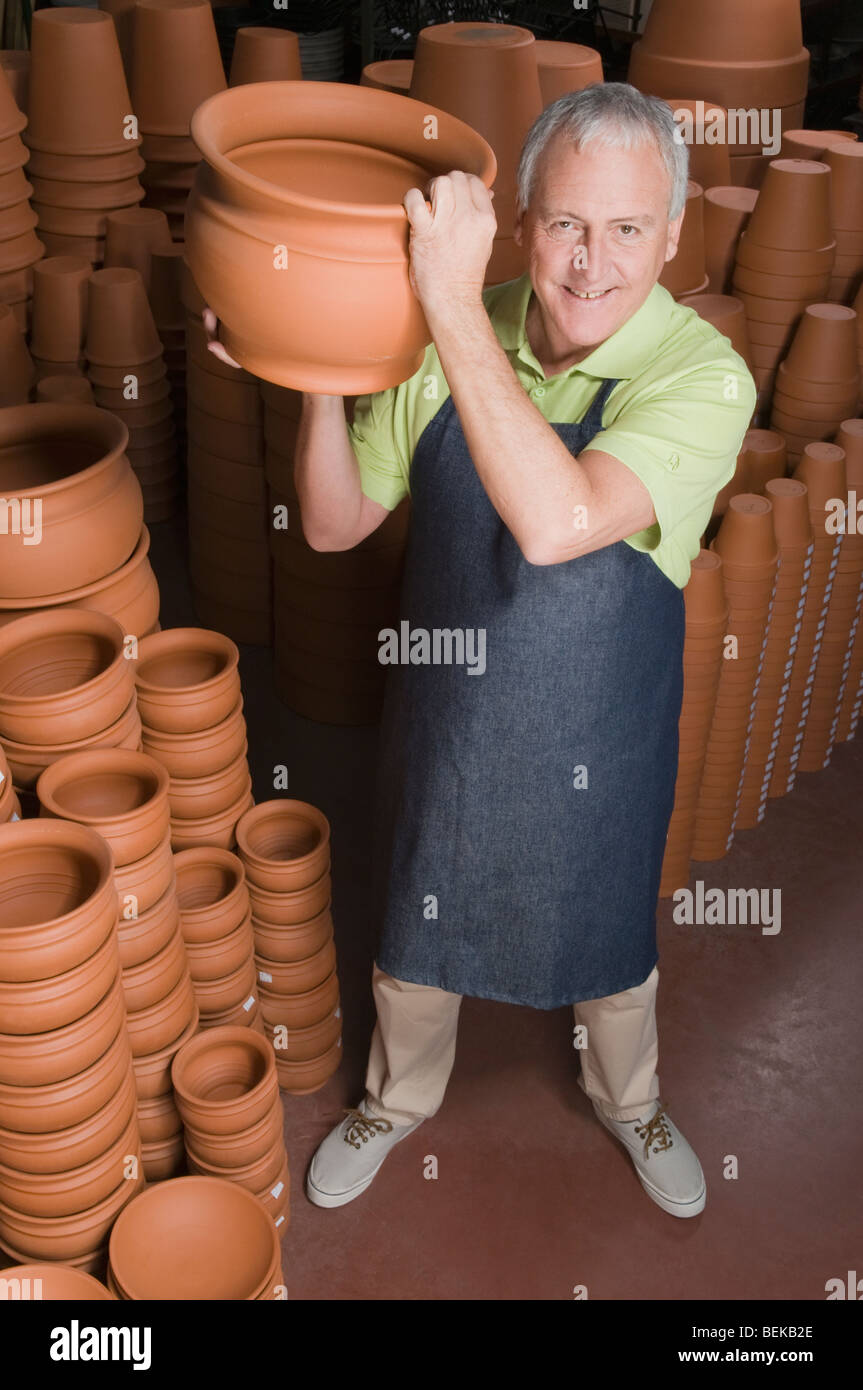 Man holding a pot in garden center Stock Photo