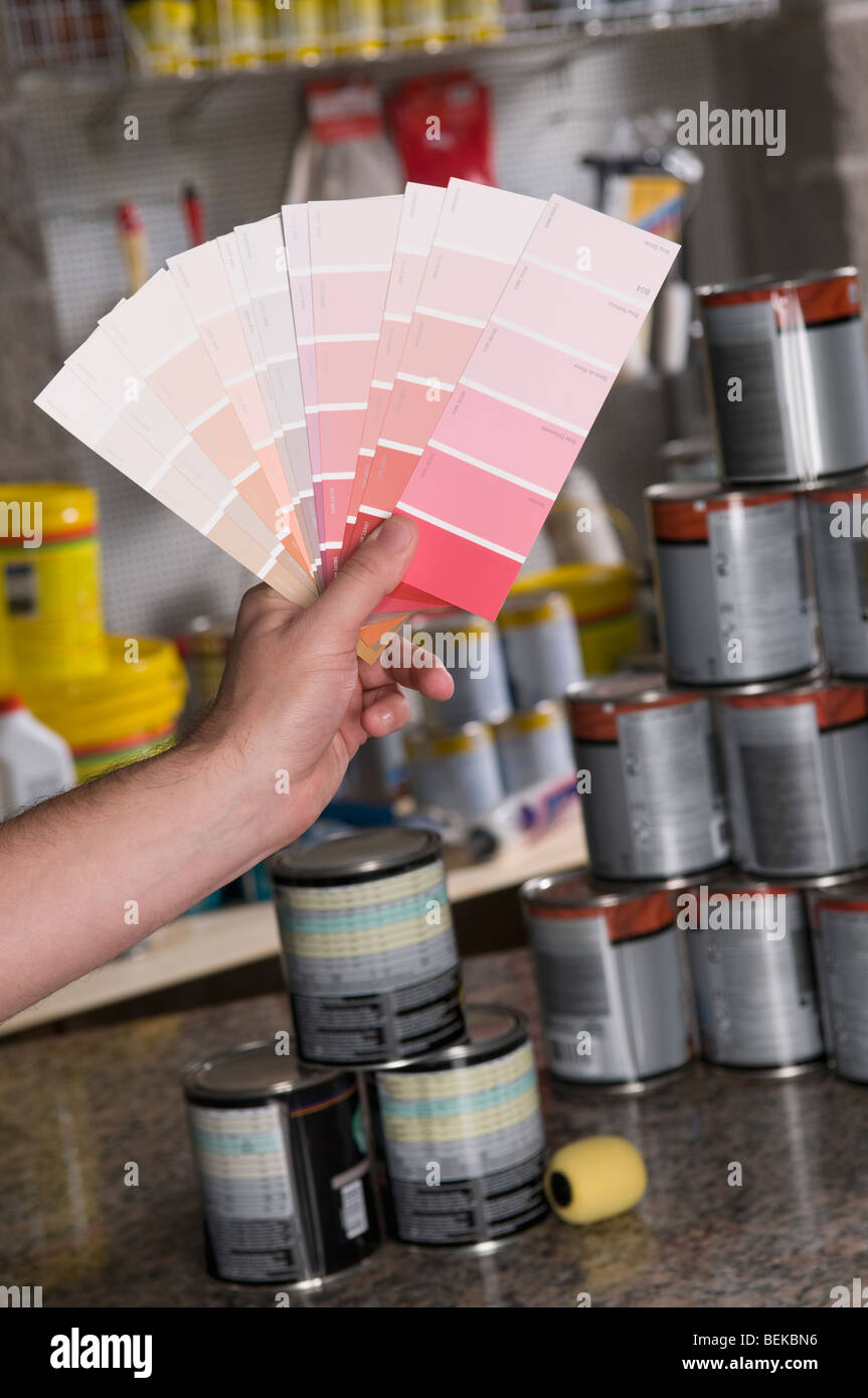 Man holding a color swatch in a hardware store Stock Photo