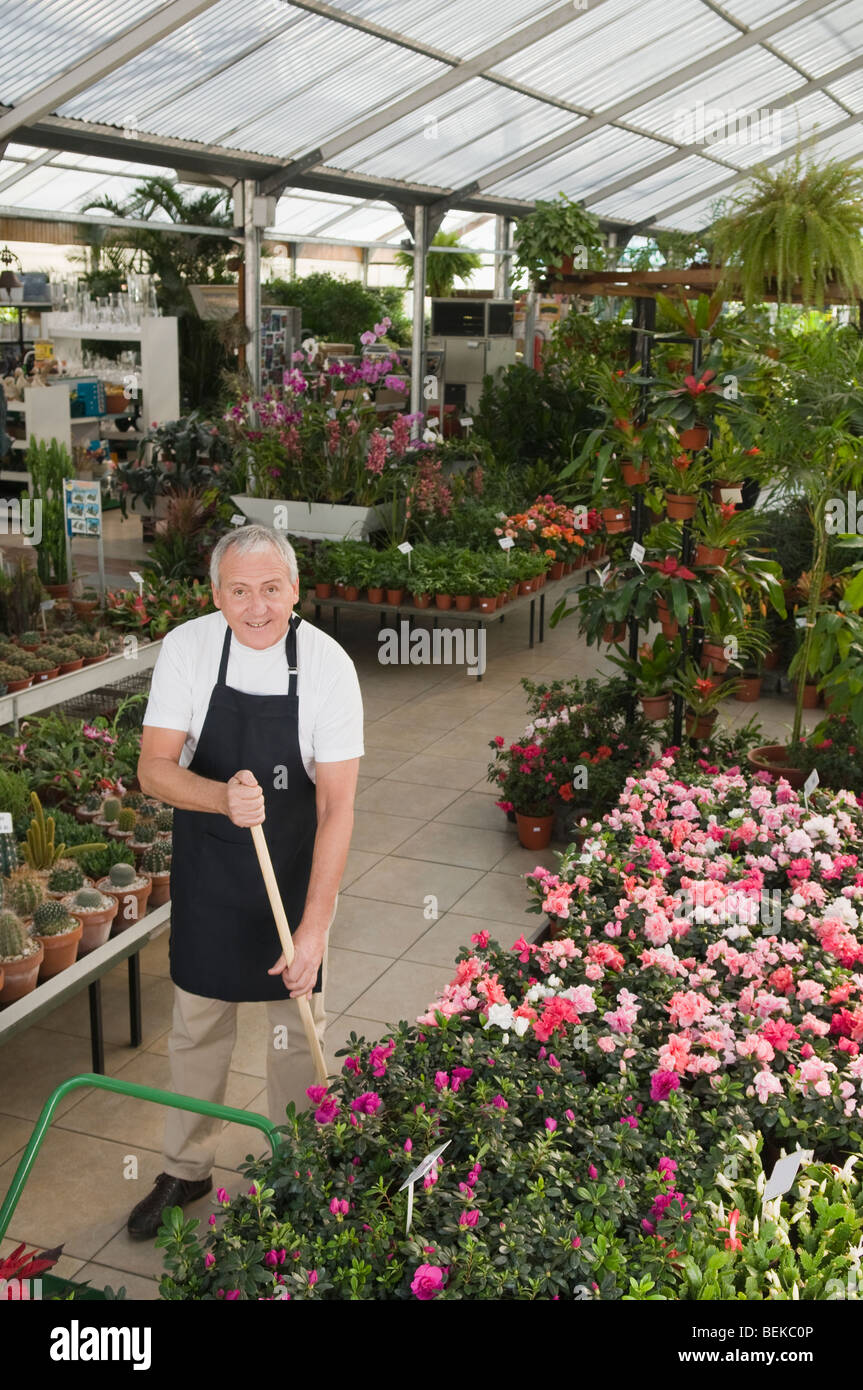 Man working in a garden center Stock Photo