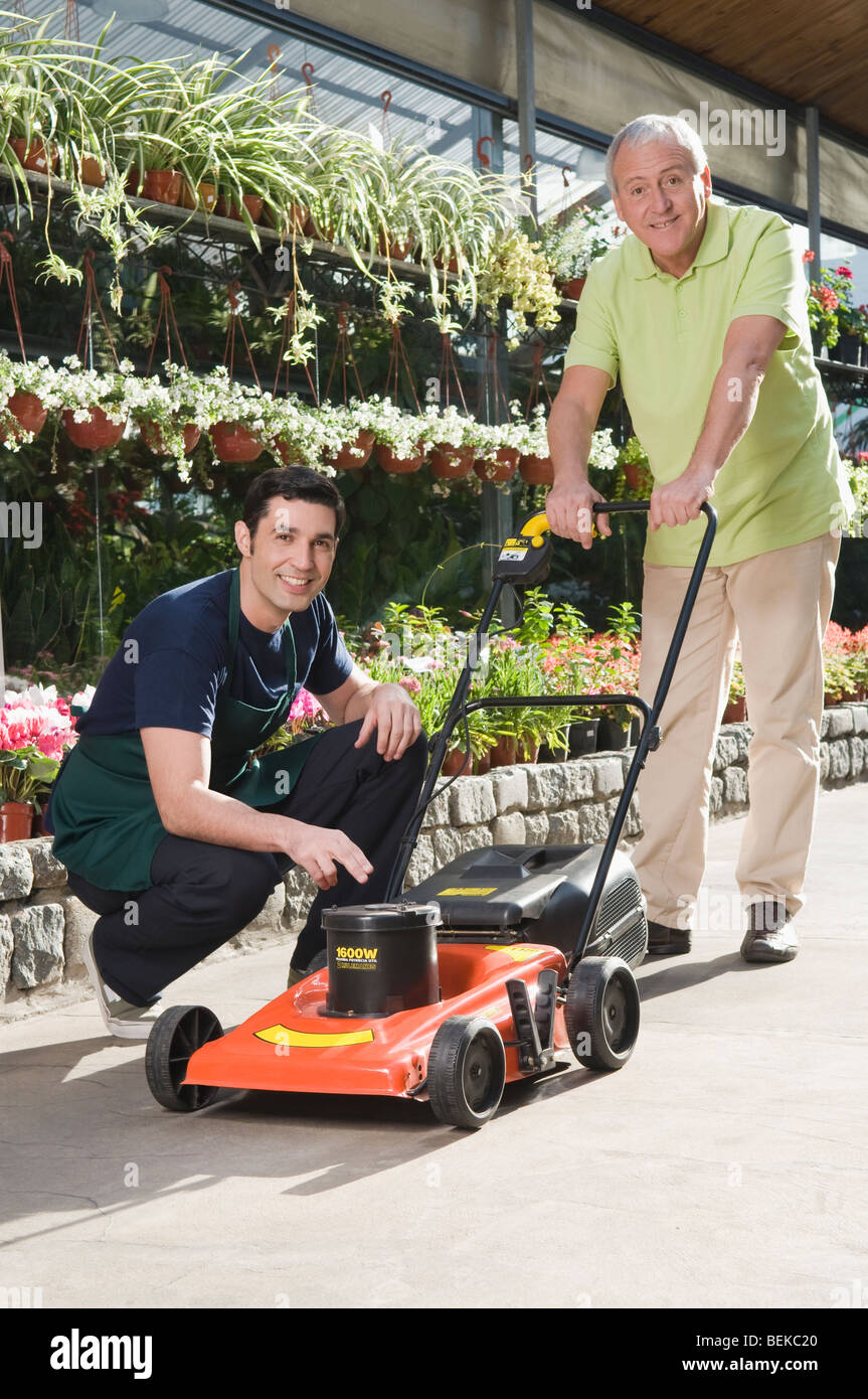 Man explaining about a lawn mower to a customer Stock Photo