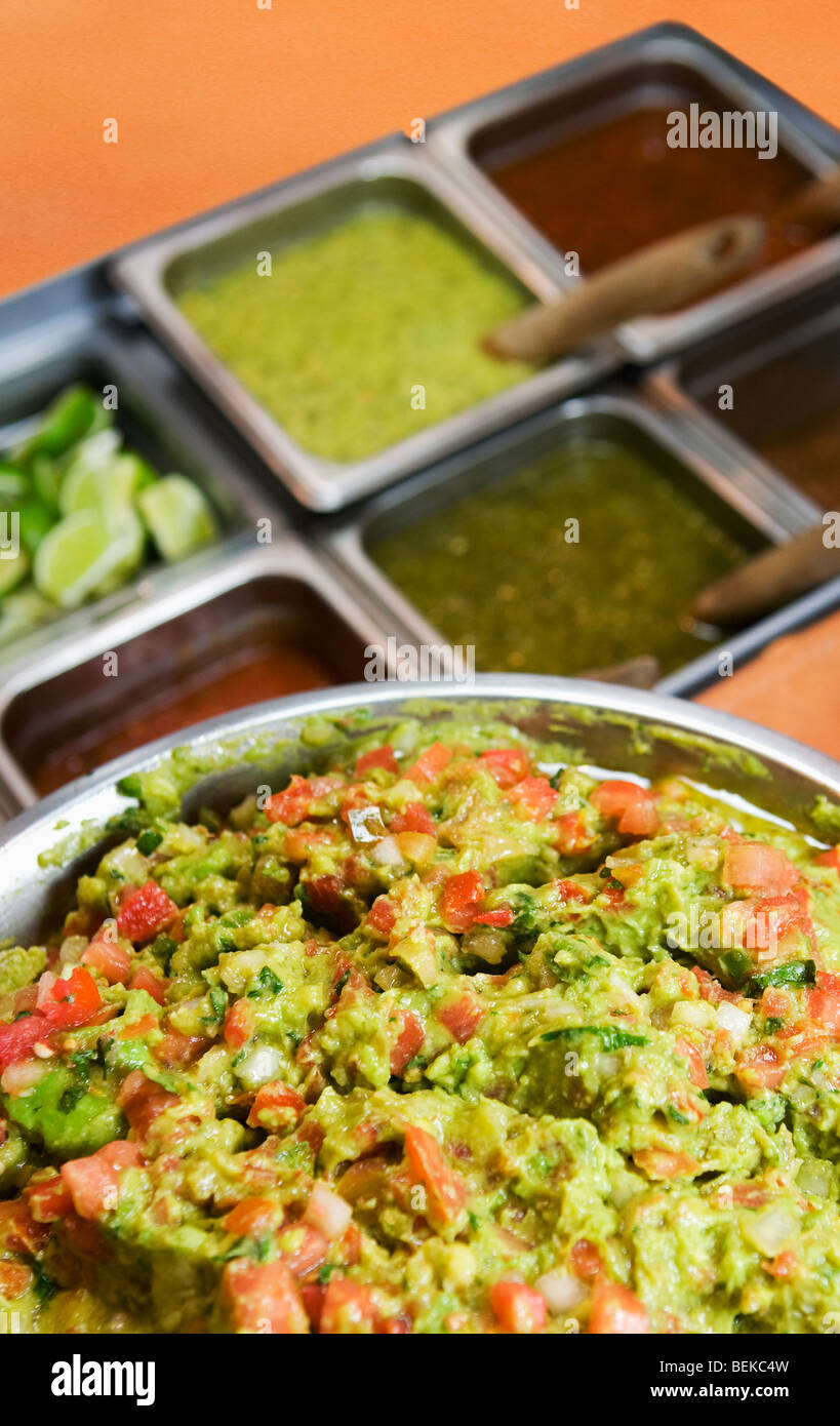 Close-up of guacamole with condiments Stock Photo