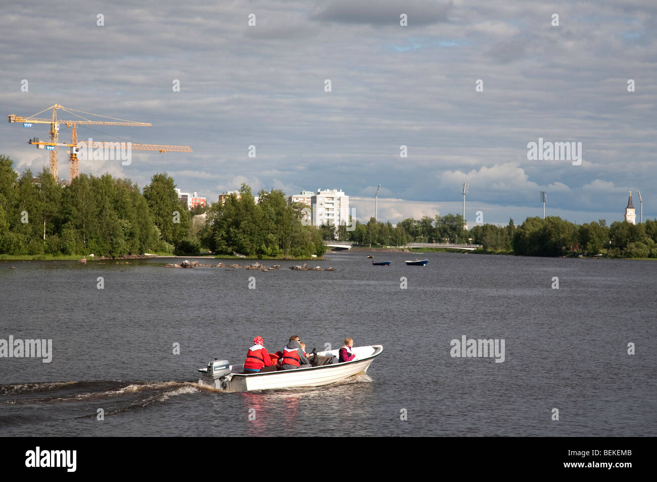 Family boating with a skiff at River Oulujoki Oulu Hartaanselkä Finland Stock Photo
