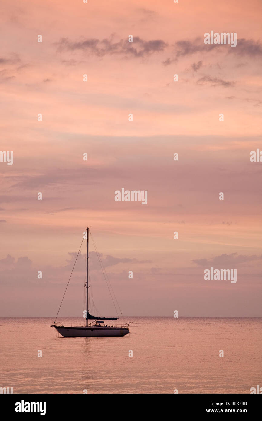 Sailboat with dramatic sunset sky at Playas del Coco, Costa Rica Stock