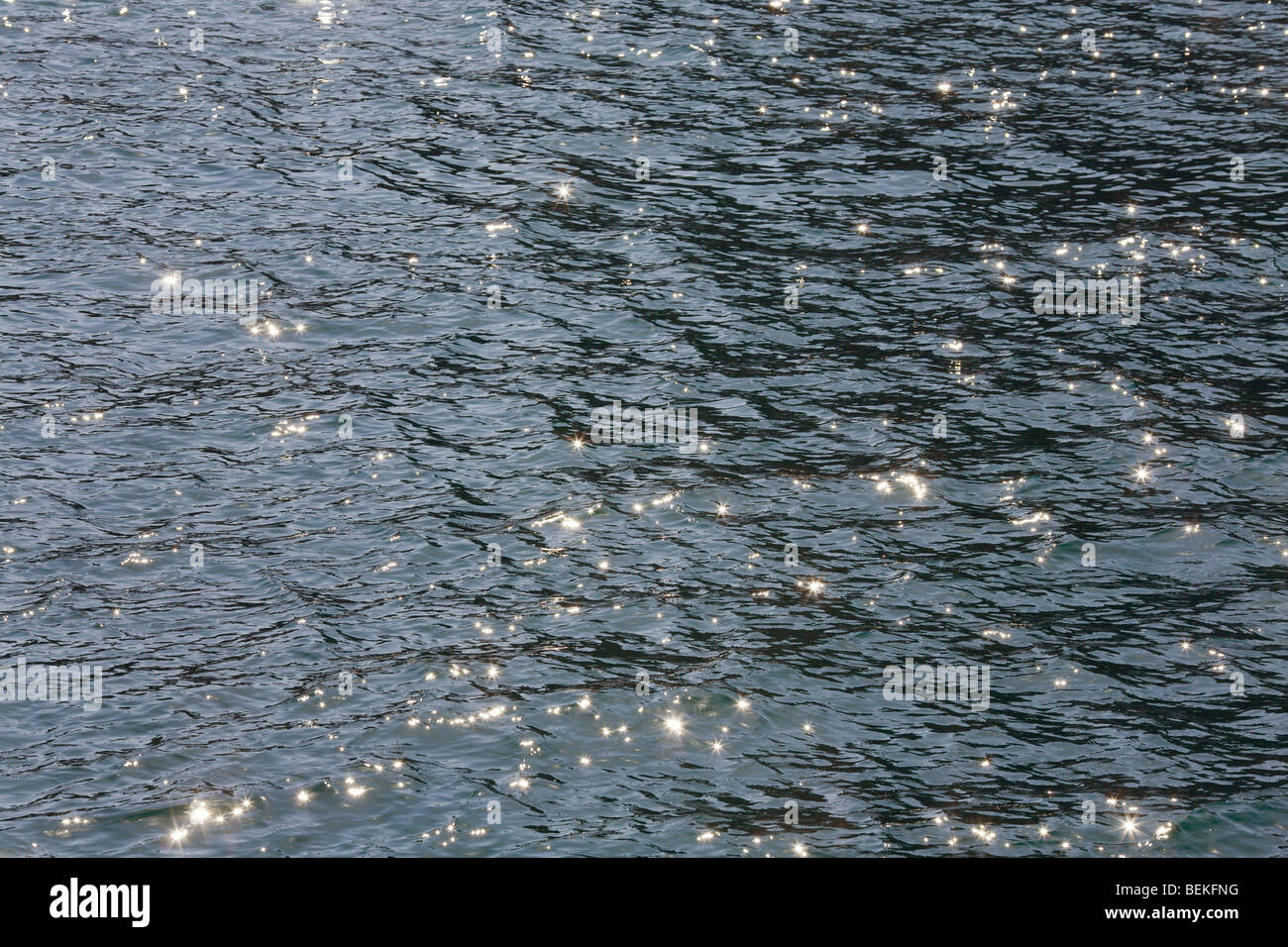 Evening sea water surface with ripple and sun reflections Stock Photo ...