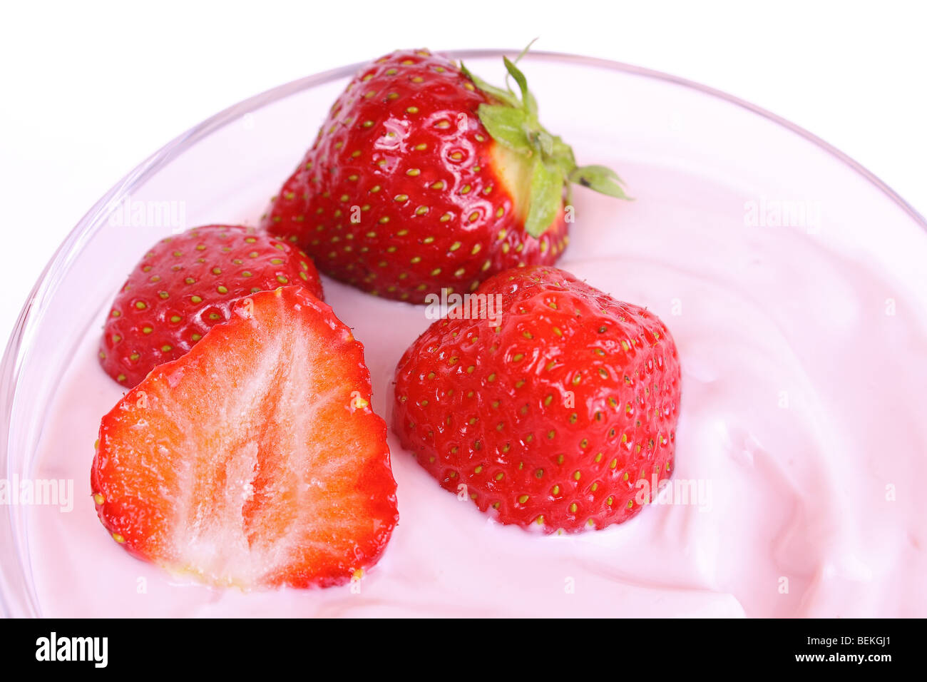 Fresh strawberries in fruit yogurt isolated on white background Stock Photo