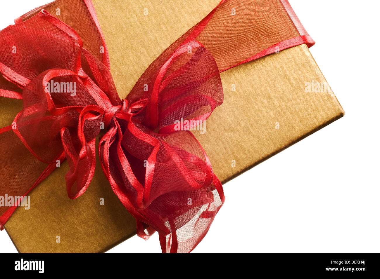 gold gift with red bow isolated on white background Stock Photo - Alamy