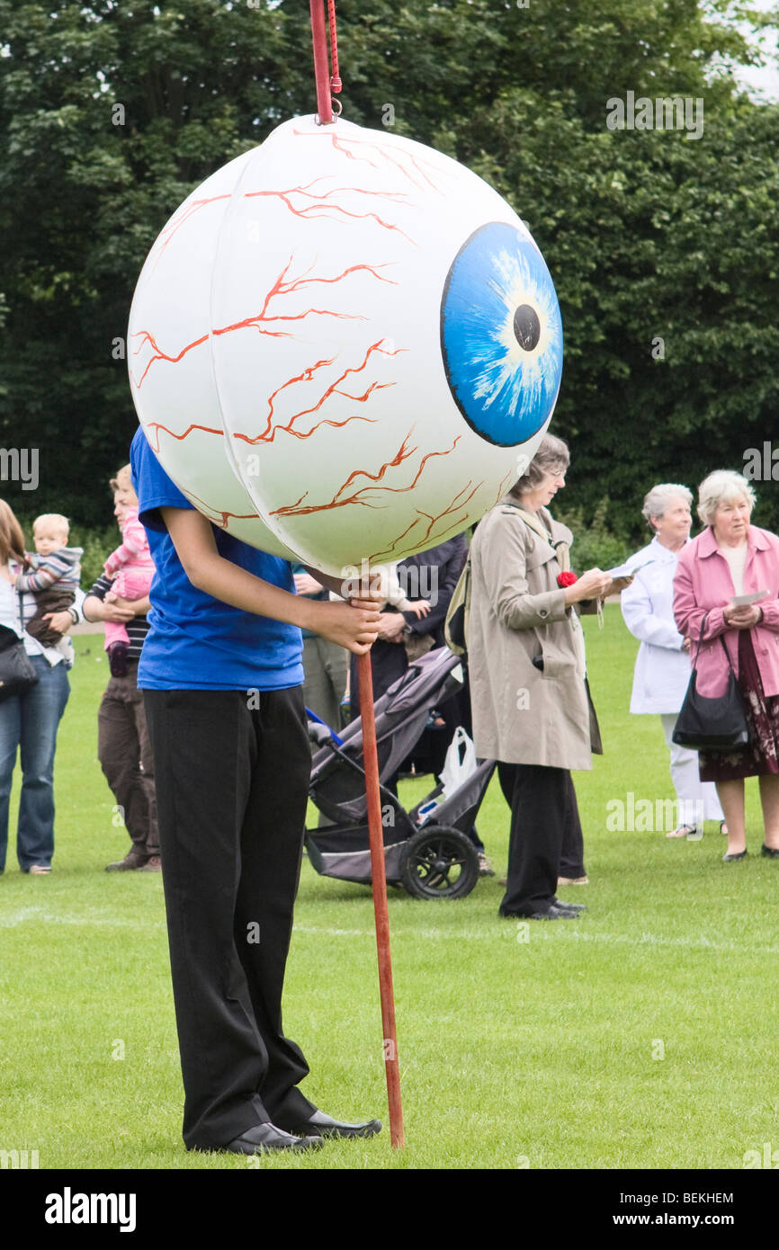 Boy holding a giant eyeball during St Albans Albantide pilgrimage Stock Photo
