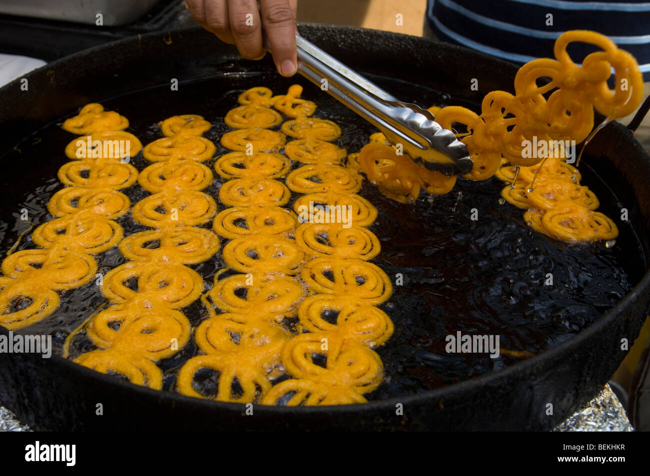 A vendor fries Indian jalebi at the Diwali street fair in the Queens neighborhood of Jackson Heights in New York Stock Photo