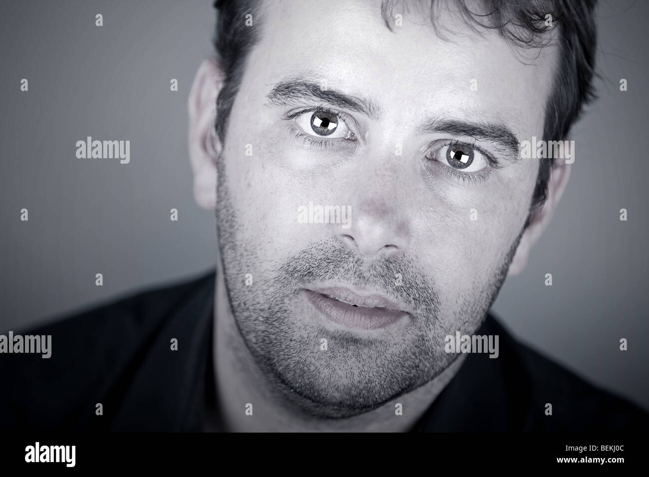 Close Up Shot of a Handsome Deaf Male with Discreet Hearing Aid Stock Photo