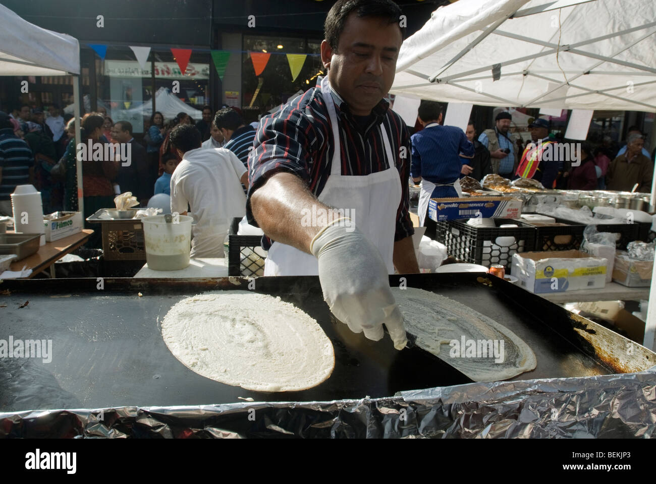 A vendor prepares dosas at the Diwali street fair in the Queens