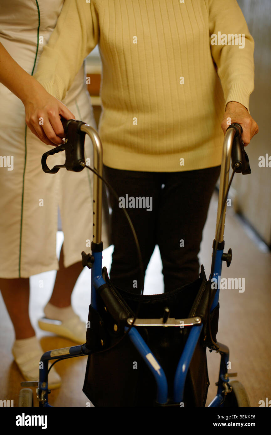 Elderly lady with Female therapist in hospice corridor Stock Photo