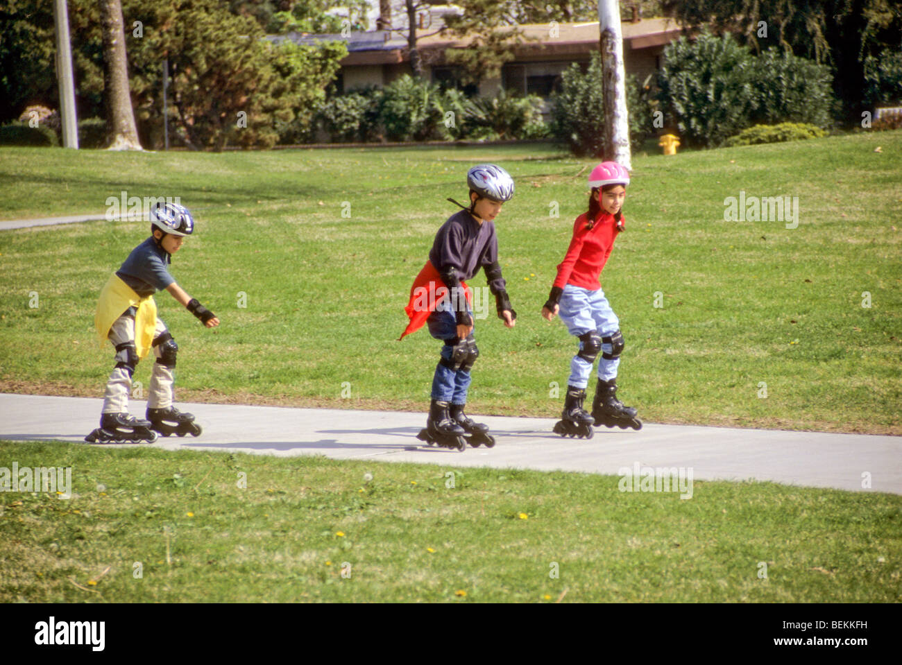 Latin boys and sister twin skate park safe helmet protection knee pad