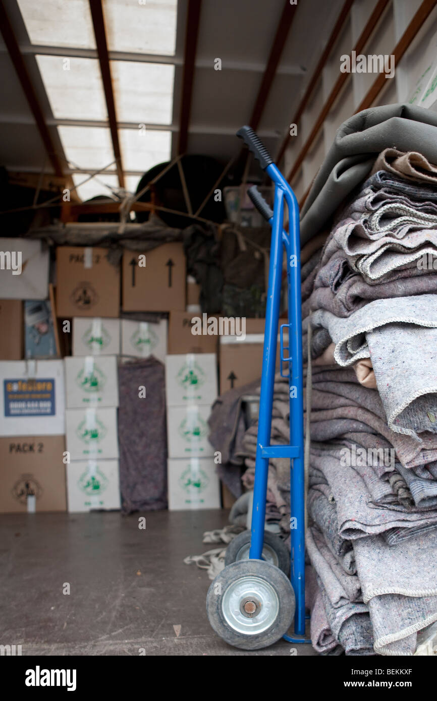 Blankets and cartons / boxes inside the back of a removal truck, in the process of moving house. Stock Photo