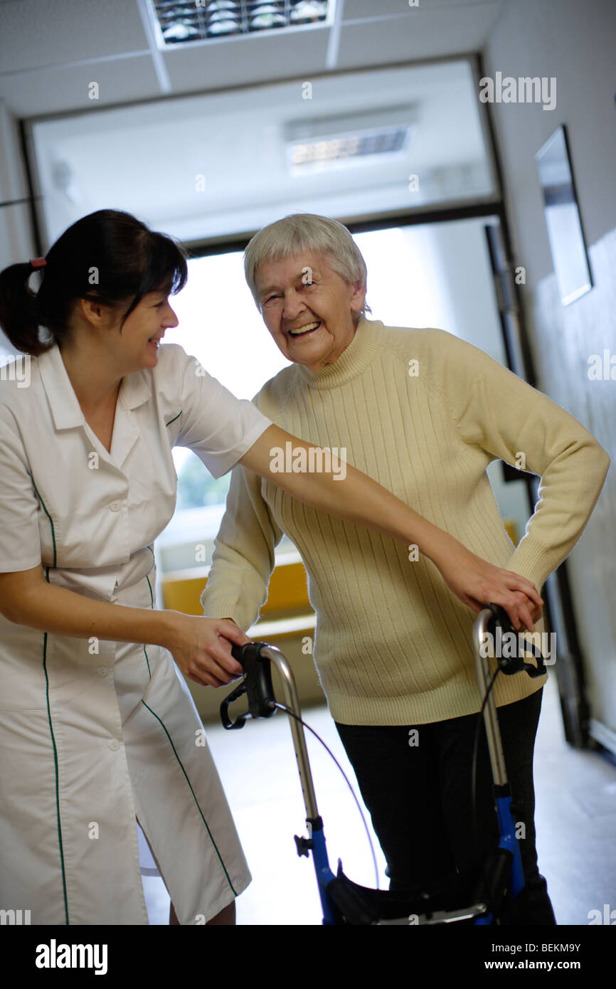 Elderly lady with Female therapist in hospic corridor Stock Photo