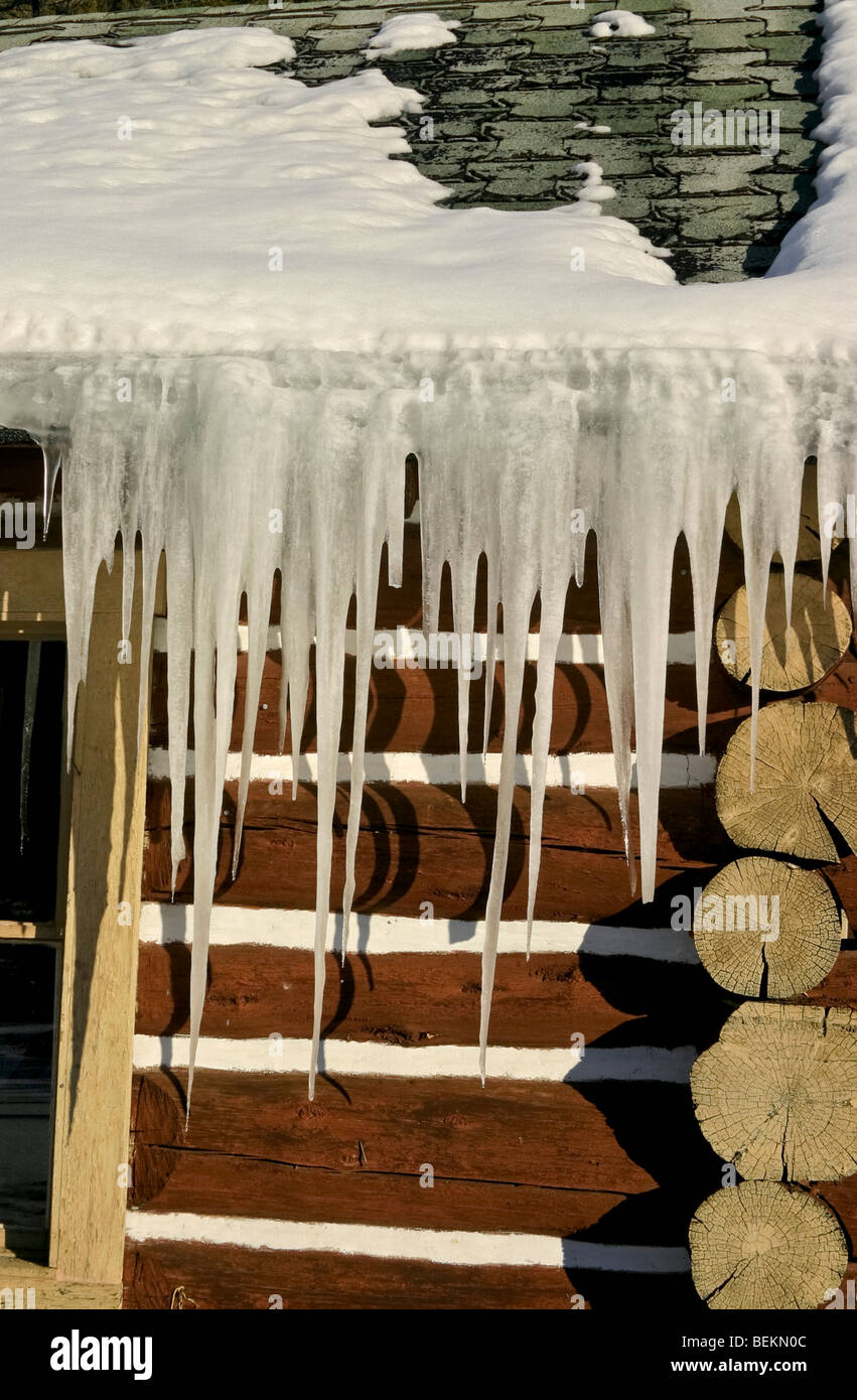 Icicles Hang From Roof Of Log Cabin On Road Leading From Bozeman