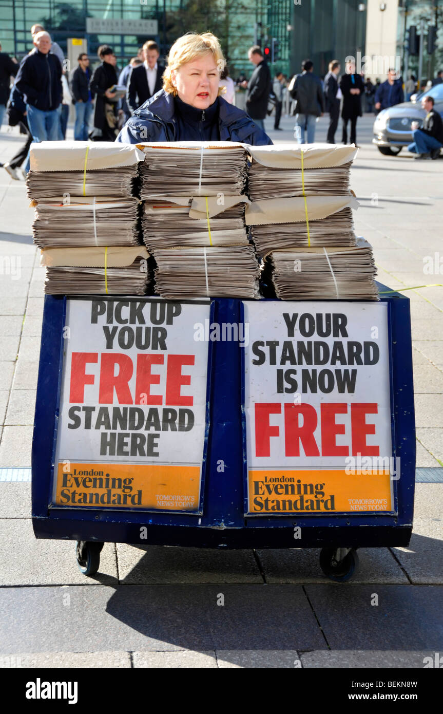 Evening Standard newspaper distributer with placard announcing papers change to being free of charge Stock Photo