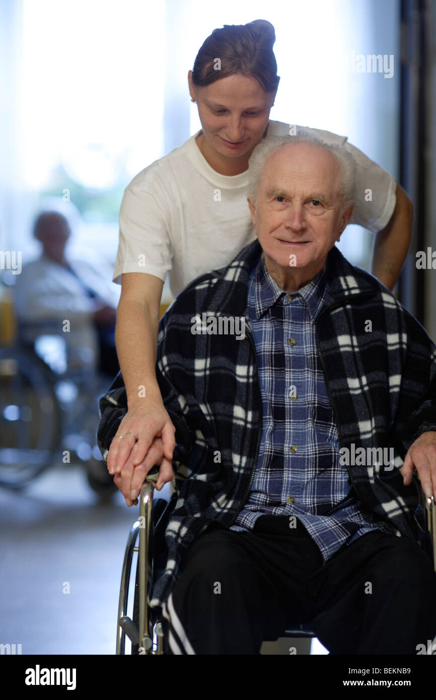 invalid man in wheelchair with female therapist Stock Photo