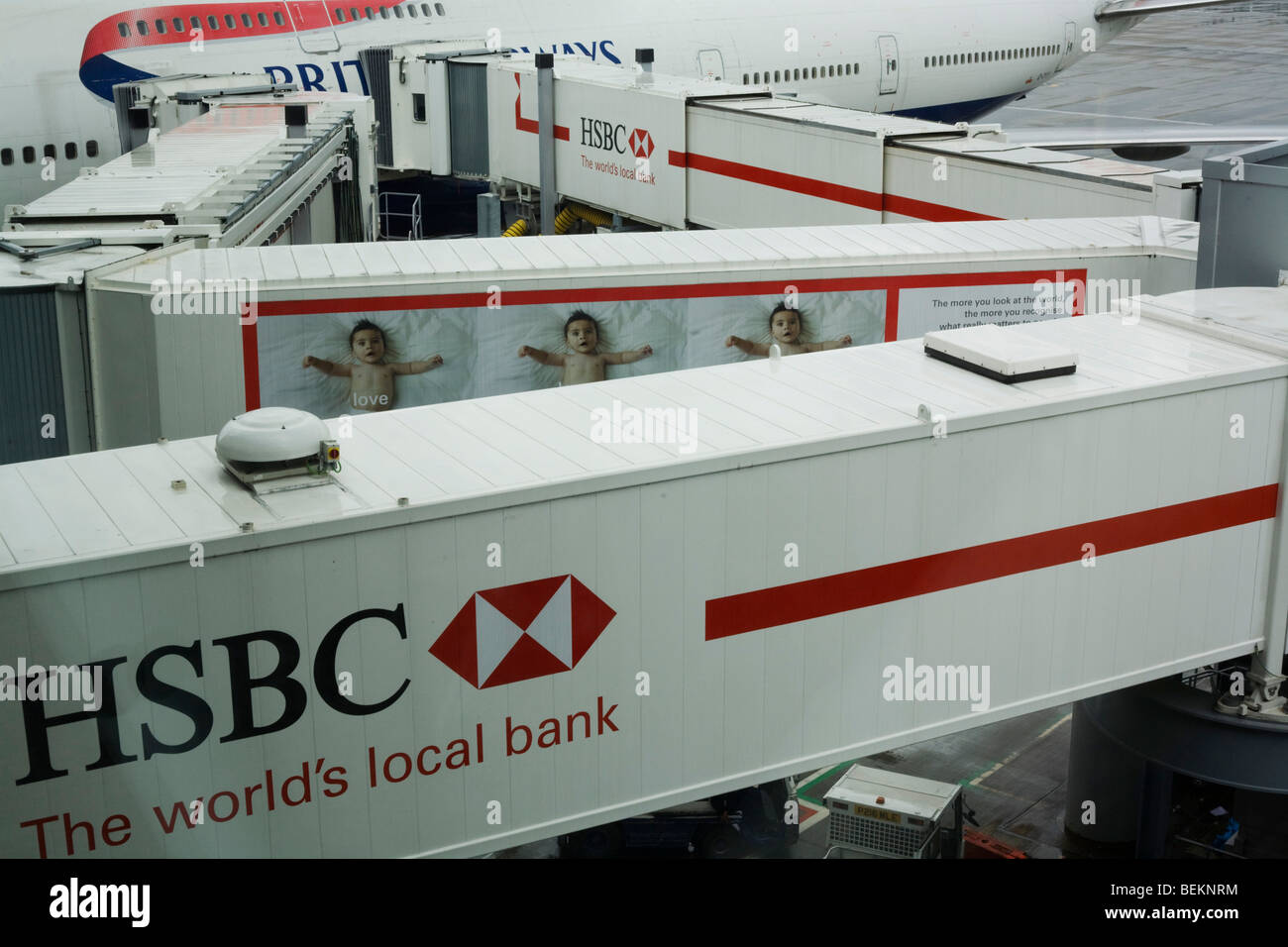 Zigzag of HSBC-sponsored passenger jetties that transport air travellers from their aircraft at Heathrow Airport's Terminal 5. Stock Photo