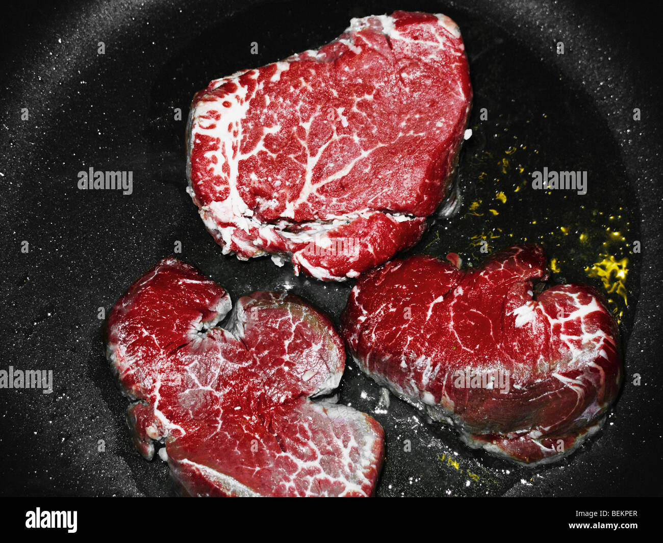 Three Steaks In A Frying Pan Stock Photo Alamy