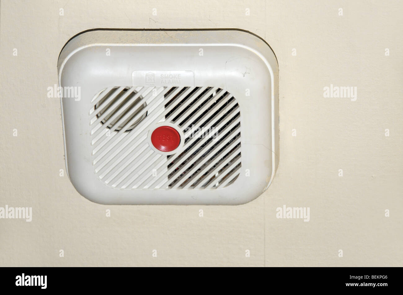 A smoke detector positioned on the ceiling of a house. Stock Photo
