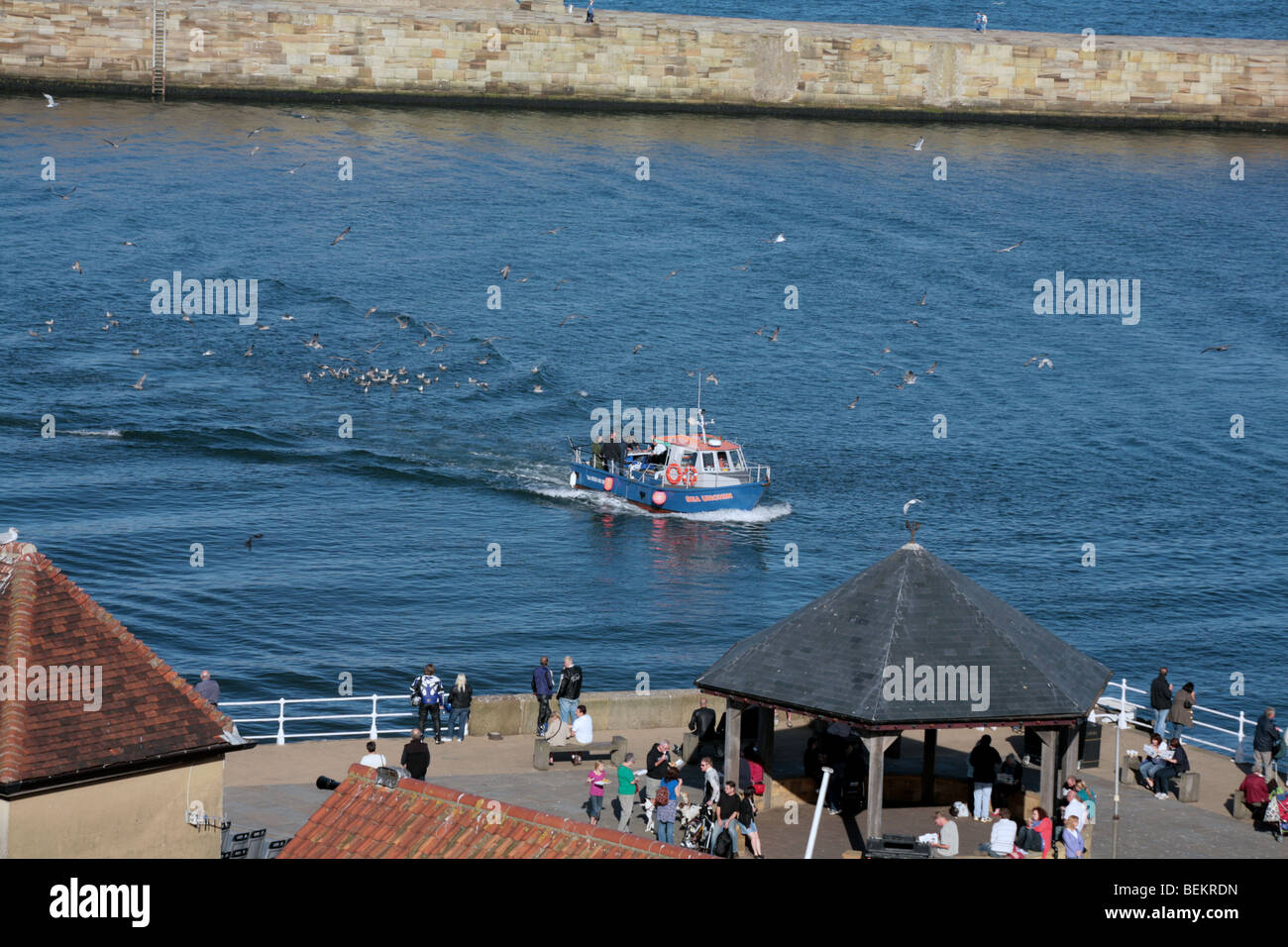 Fishing boat entering The Harbour Whitby North Yorkshire England Stock ...
