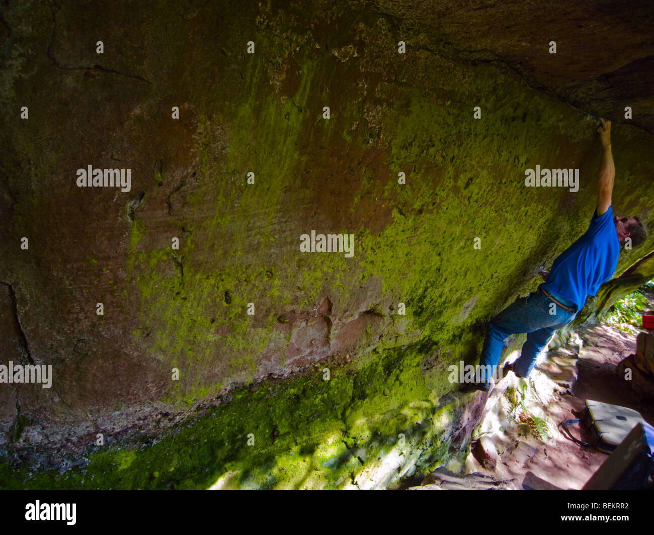 Climber doing a boulder problem in the Churnet Valley Staffordshire Stock Photo
