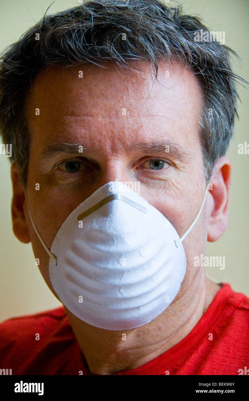 Man wearing a protective swine flu mask Stock Photo
