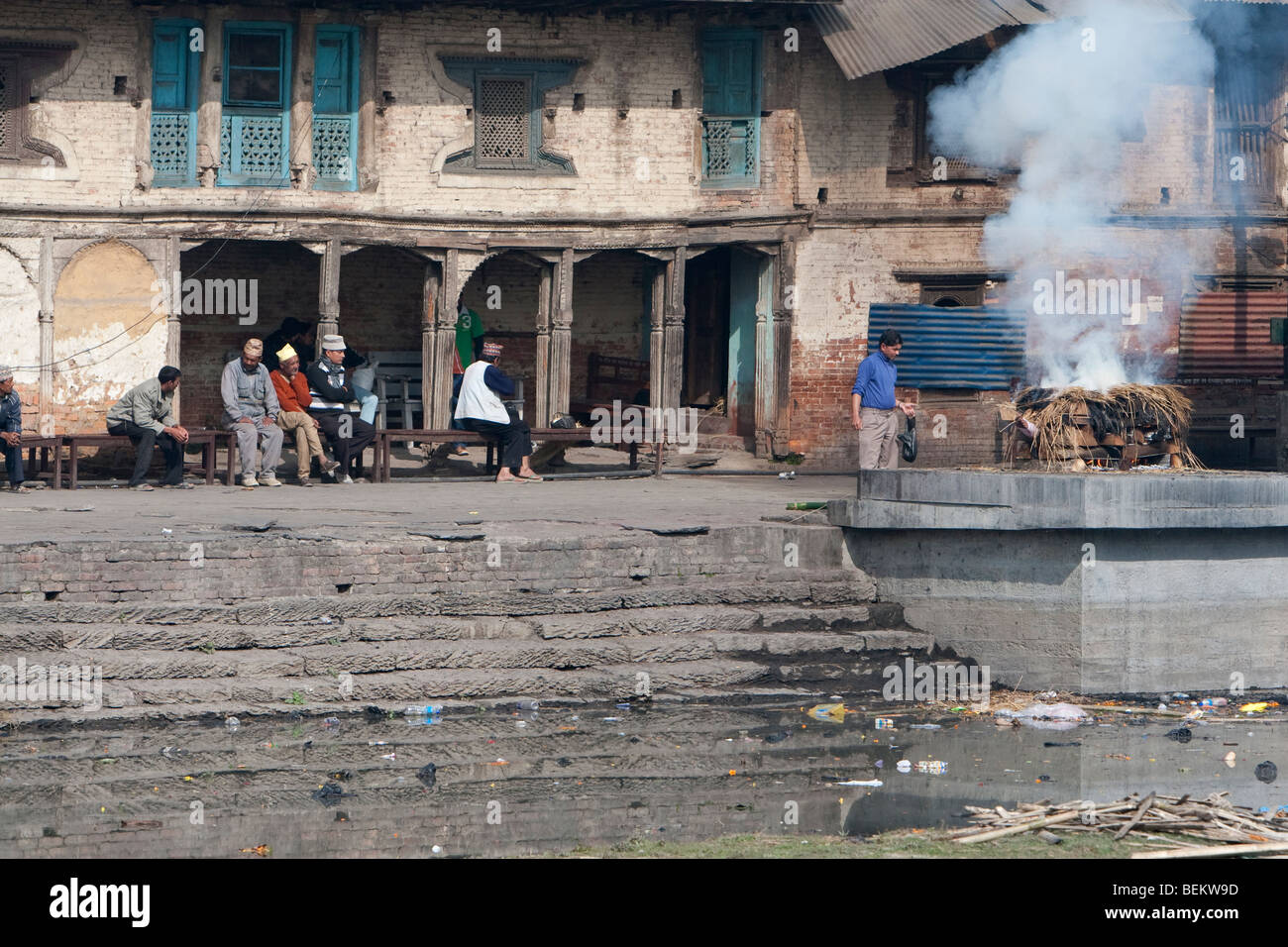 Pashupatinath, Nepal. A Family Member Oversees a Cremation on a Ghat on the Banks of the Bagmati River. Stock Photo