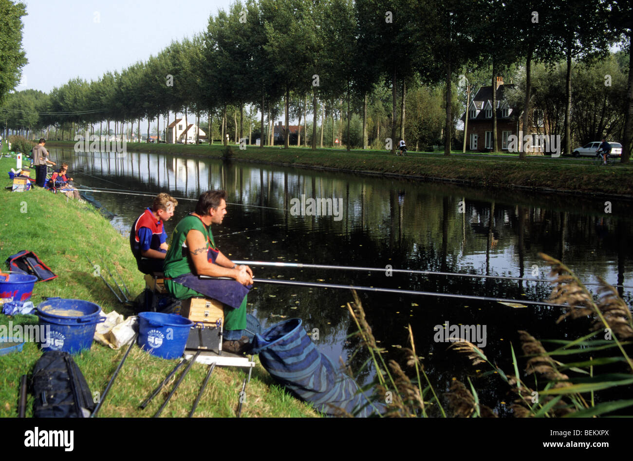 Anglers fishing during competition along the Damme Canal, West Flanders, Belgium Stock Photo