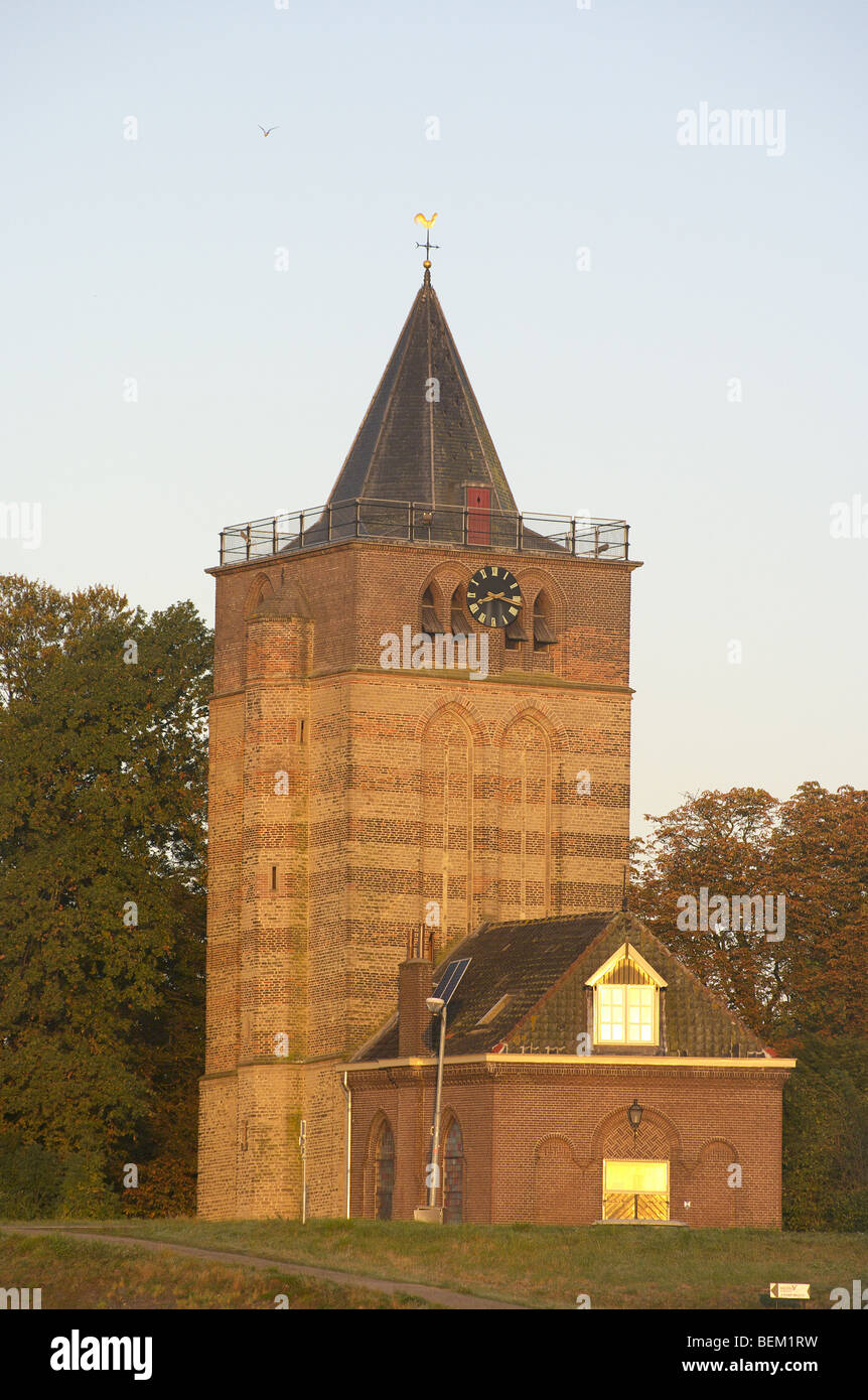 Autumn sunrise on the old square tower in Varik in the Netherlands Stock Photo