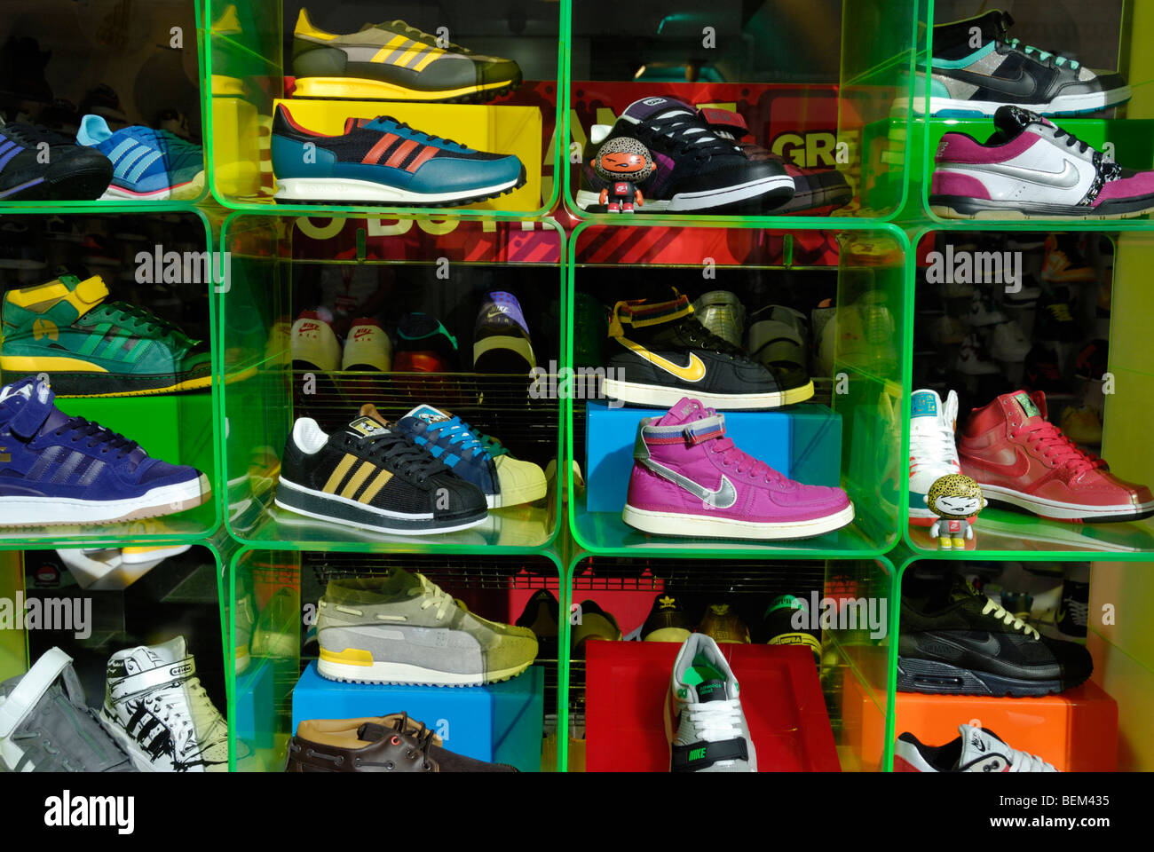 Colourful display of training shoes in a UK shop window Stock Photo