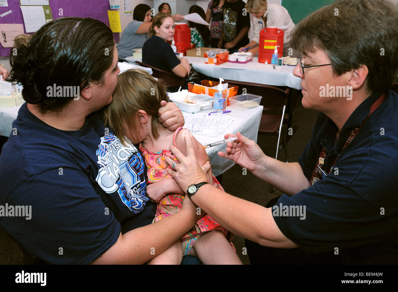 An 5-year-old girl is vaccinated for the 2009 H1N1 influenza, also known as the Swine Flu, with an inactivated flu shot. Stock Photo