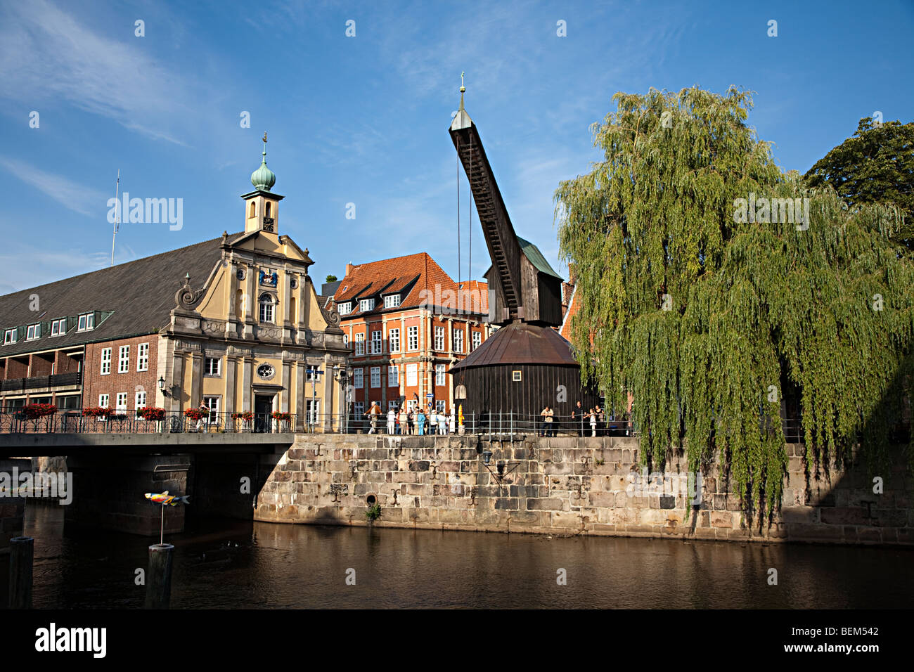 Old wooden crane and salt warehouse on the Ilmenau river in Luneburg Germany Stock Photo