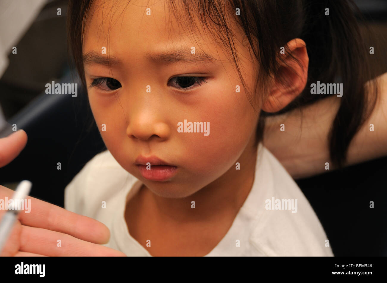 A 5-year-old girl is vaccinated for the 2009 H1N1 influenza, also known as the Swine Flu, with an intranasal vaccine. Stock Photo