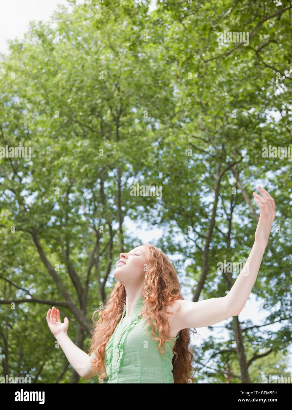 Woman under trees Stock Photo