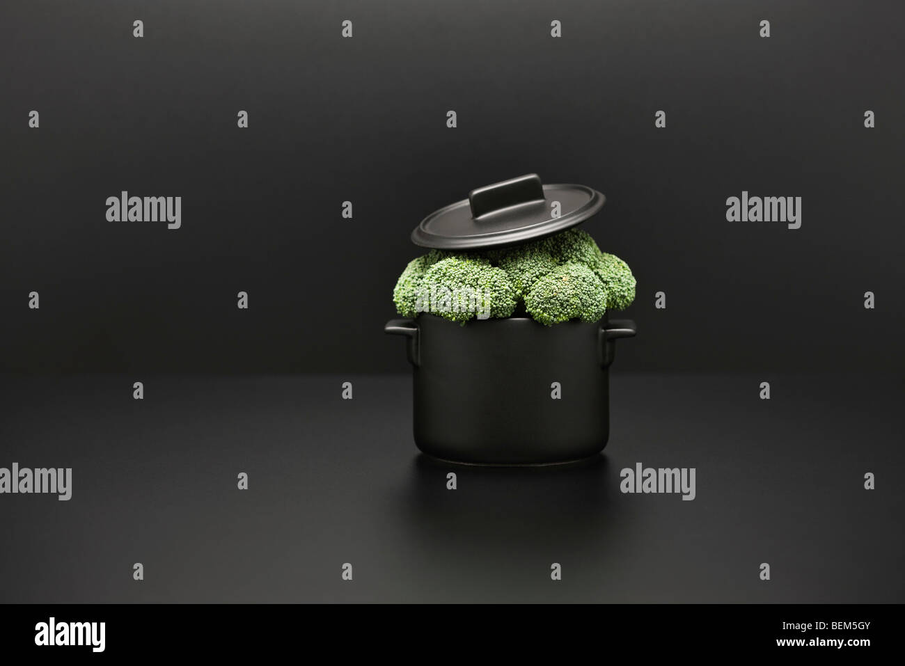 Food concept, fresh broccoli overflowing pot Stock Photo
