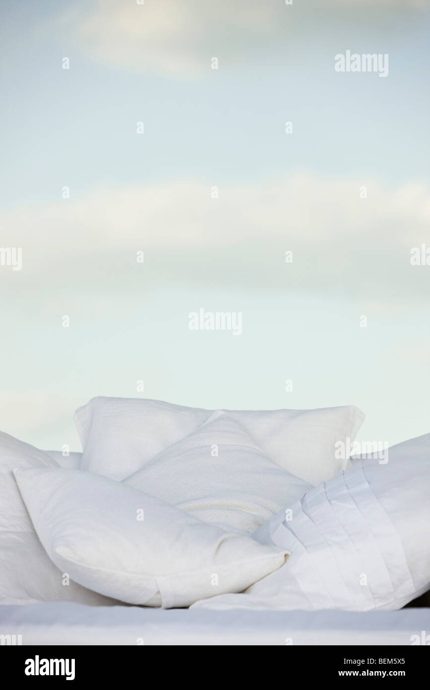 Pillows against background of clouds in pale sky Stock Photo