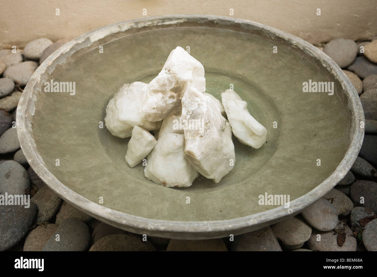 Zen fountain, water in shallow bowl with rocks in center Stock Photo