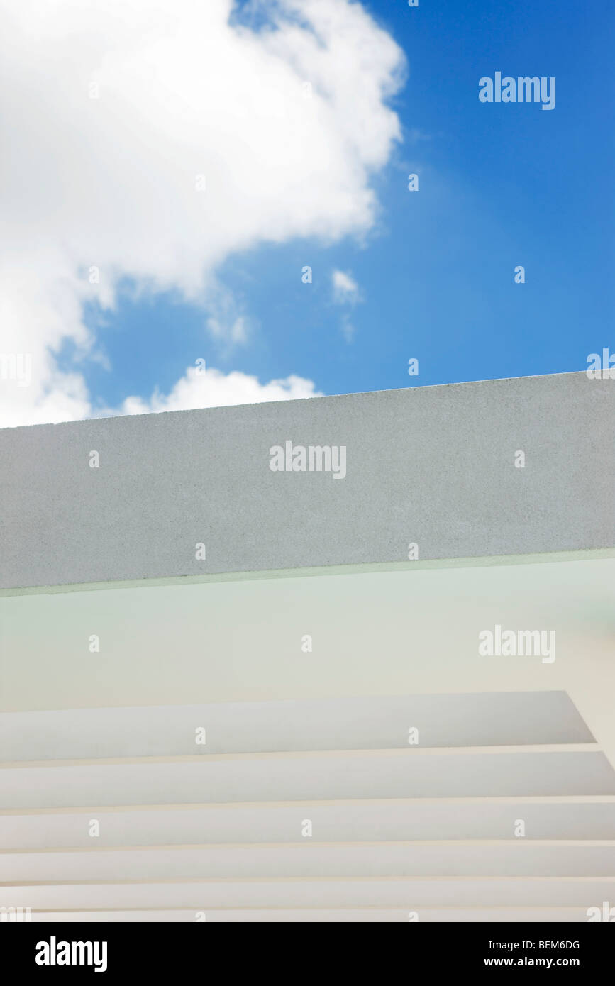 Cloud against blue sky above building wall Stock Photo