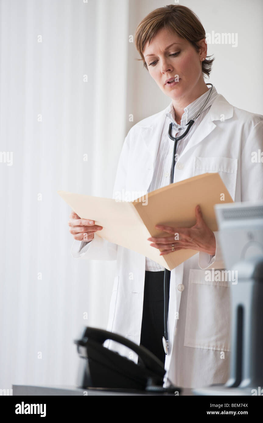 Female doctor reviewing notes Stock Photo